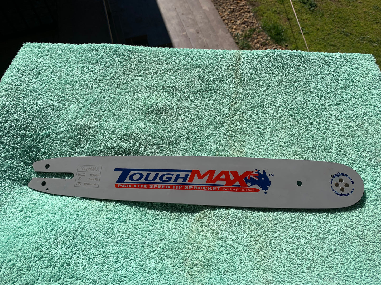 Chainsaw guide bar on outdoor bench, clearance stock